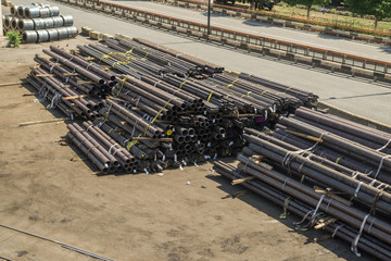 Stacks of steel pipes unloaded on the ground.