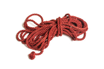 Red jute rope for shibari isolated on white background.