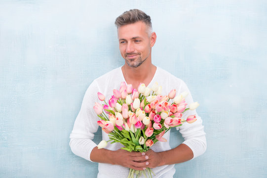 Giving Her All Best. Valentines Day And Anniversary. How To Be Romantic. Romantic Gentleman. Man Mature Confident Macho With Romantic Gift. Handsome Guy Flowers Bouquet Romantic Date. Fresh Tulips