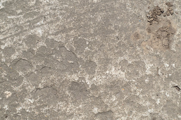  Gray concrete texture with a small pattern in the upper right corner in the form of cracks and stones.