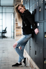 Fashion blonde girl with black jacket and ripped jeans