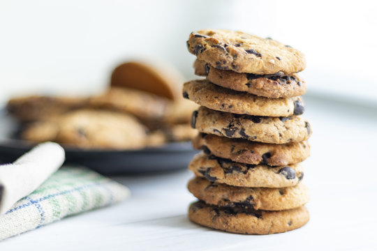 stack of chocolate chip cookies on white background