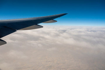 Obraz premium Aerial View from an Airplane. Flying above Clouds at Sunrise