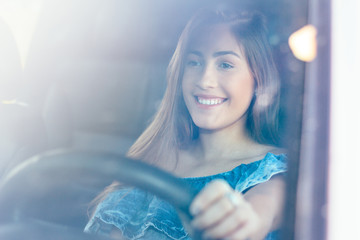 Confident, smiling and happy woman driving the car. Concept of travel, tourism and female independence. Concept of lifestyle