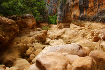 A steep mountain dry river slot canyon. Steep rock cliff on all sides. Croatia, Canyon Čikola