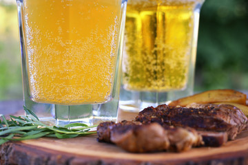 Fried beef steak with chili pepper served on wooden board