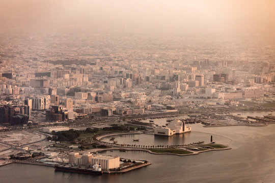 Aerial view of Doha, Qatar and harbor with haze and dust.