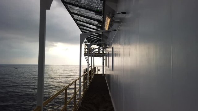 Walking on the grating beside an accommodation of a tender drilling rig