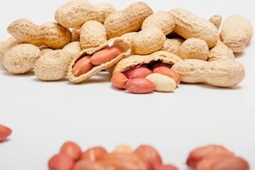 Large peeled peanuts close-up of beans in the shell. Unpeeled peanuts in the shell. Peanuts, for background or texture. Growing organic protein