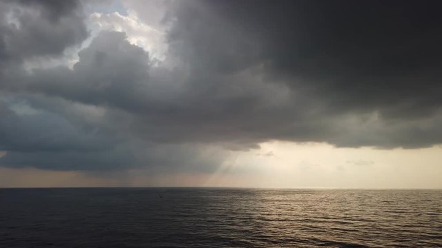 Stormy weather, high wind and wave in the middle of the ocean with dark clouds before storm
