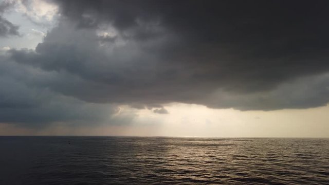Stormy weather, high wind and wave in the middle of the ocean with dark clouds before storm