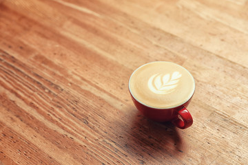 Cup of fresh coffee on wooden table. Space for text