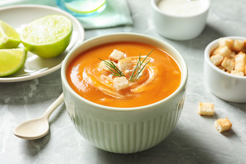 Bowl of tasty sweet potato soup served on table