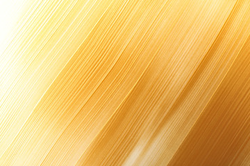 Strokes of gold paint as background, top view