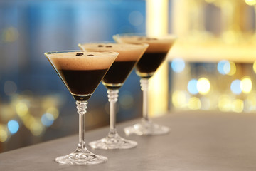 Glasses of delicious Espresso Martini on bar counter. Alcohol cocktail