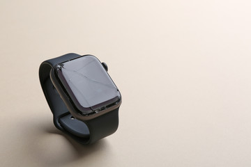 Broken smart watch on color background, space for text. Repair service