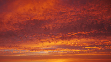 Vivid, red moody sky at sunset with clouds