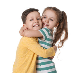 Cute little boy and girl hugging on white background