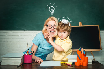 Back to school. Home schooling or private school. Female teacher and schoolboy in class at school....