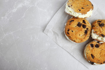Sweet delicious ice cream cookie sandwiches on table, top view. Space for text