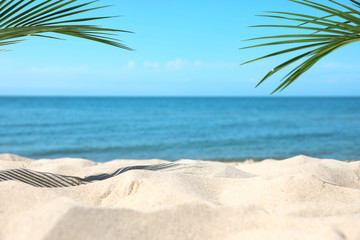 Sandy beach near sea on sunny day