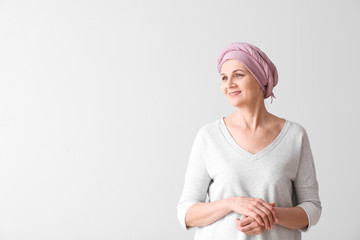 Mature woman after chemotherapy on light background