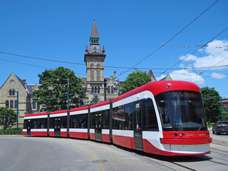 Long articulated streetcar bends as it goes around a curve