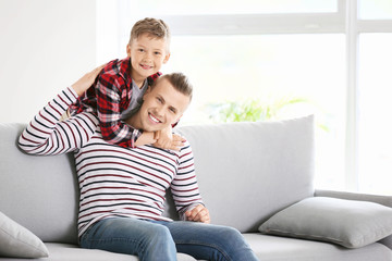 Happy father and son at home