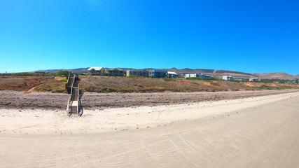 Drone aerial view of Australian wide open beach and coastline, taken at Sellicks Beach, South Australia.