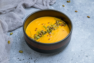 Soup cream of pumpkin on bowl