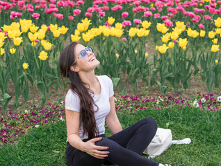 woman in a city spring park. Blooming flowers