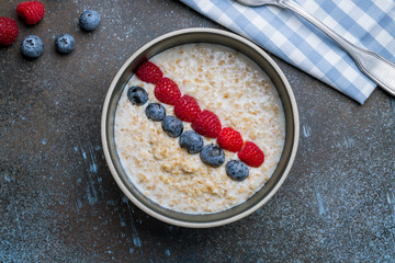 Oatmeal with berries on bowl