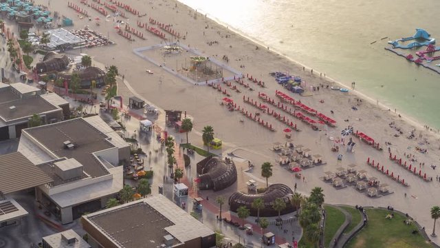 Waterfront overview Jumeirah Beach Residence JBR skyline aerial timelapse with yacht and boats. Shops, restaurants and other entertainment from above