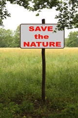 white sign, road sign in the forest on a wooden post with the inscription save the natur, concept