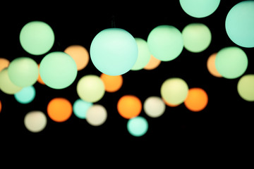 Colored pendant lights on a dark background