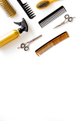 Combs, sciccors and hairdresser tools in beauty salon work desk on white background top view space for text