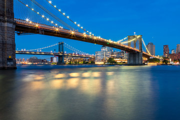 Fototapeta na wymiar Long Exposure Picture of the Brooklyn Bridge Lighted Up At Night