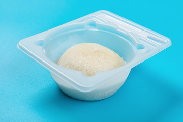 mochi dessert ice cream in a plastic cup on blue background