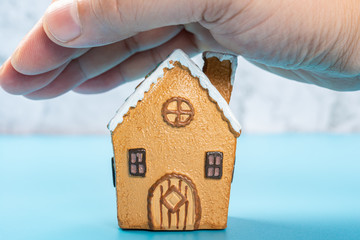 house model covered by a hand concept of home insurance and safety