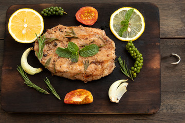 steak with lemon and spices on butcher background
