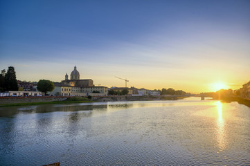 Fototapeta na wymiar June 6, 2019 - Florence, Italy - A view of Florence, along the Arno River, in the Tuscany region of Italy at sunset.