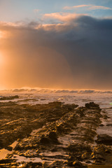 Obraz premium Waves and Rocks at Beach at Sunrise