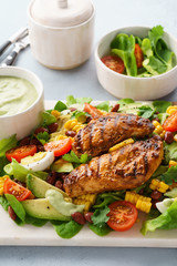 Grilled chicken breast and vegetable salad with ranch dressing.
