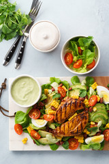 BBQ chicken cobb salad with avocado ranch dressing.