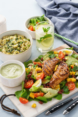 Grilled chicken with vegetable salad, soup and cold lemonade.