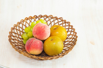 Muscat grape ,peach,peer on the basket