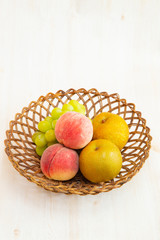 Muscat grape ,peach,peer on the basket