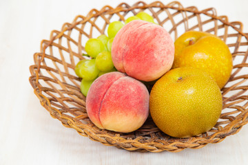Muscat grape ,peach,peer on the basket