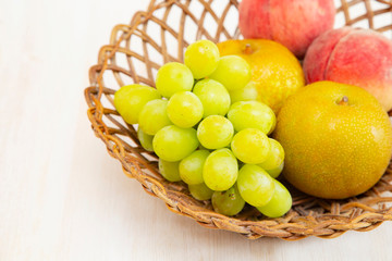 Muscat grape ,peach,peer on the basket