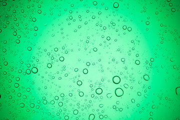 Rain droplets on green glass background, Water drops on glass.